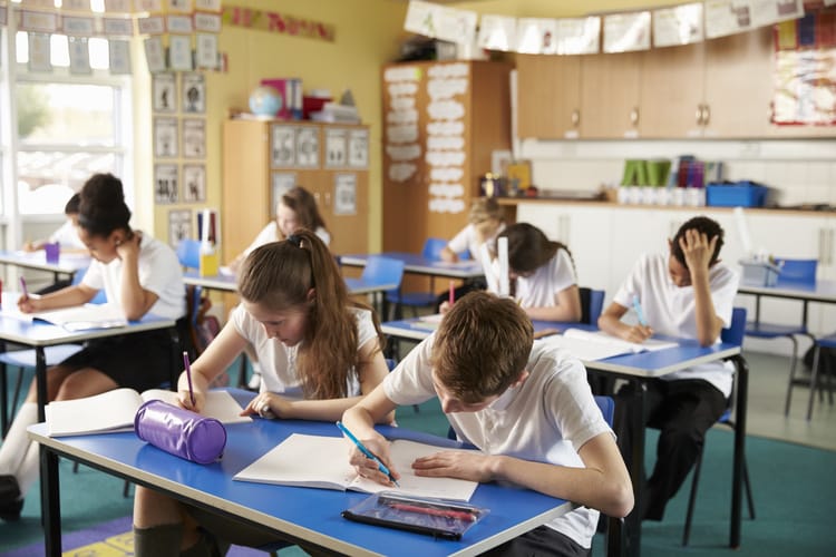 Class of primary school kids studying in a classroom primary school in the uk